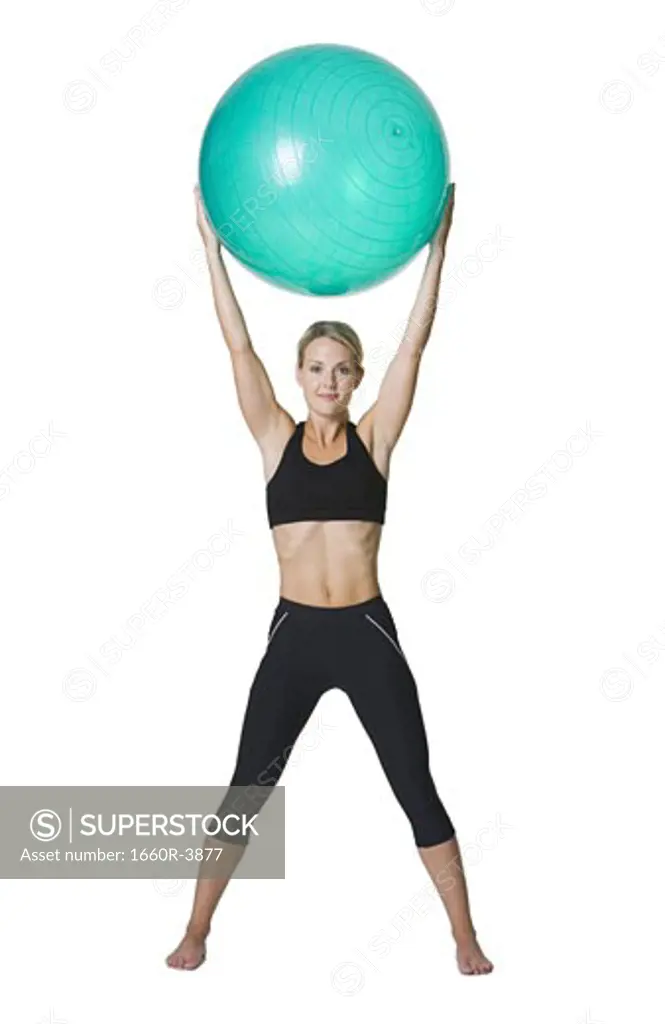 Portrait of a young woman holding a fitness ball