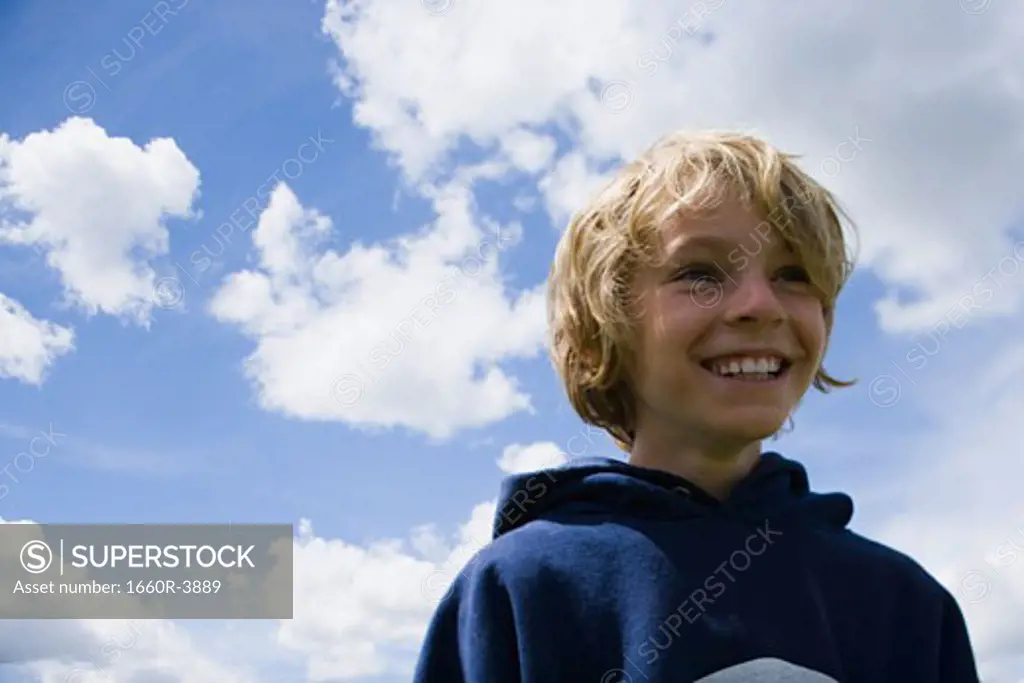 Low angle view of a boy smiling