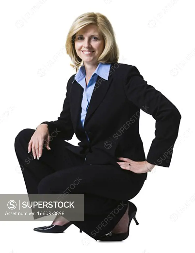Portrait of a businesswoman crouching with her hand on her hip
