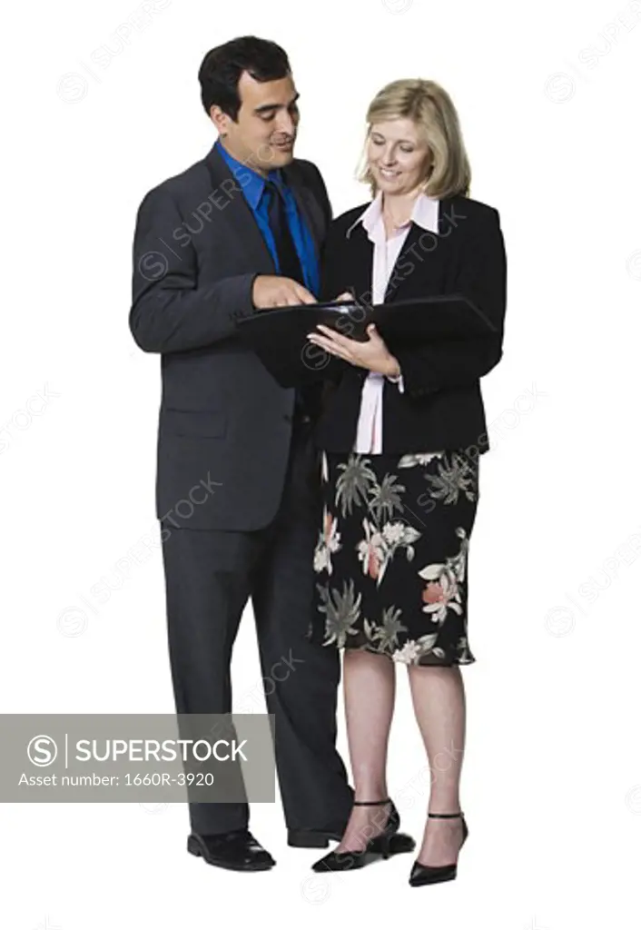 Businessman and a businesswoman looking over paperwork