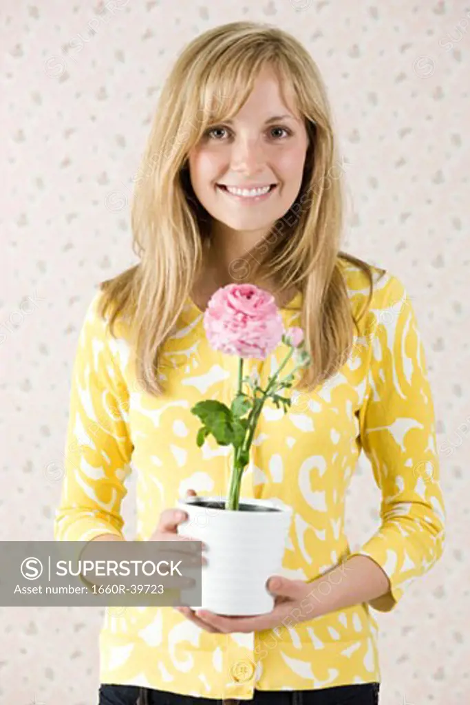 woman holding a potted flower