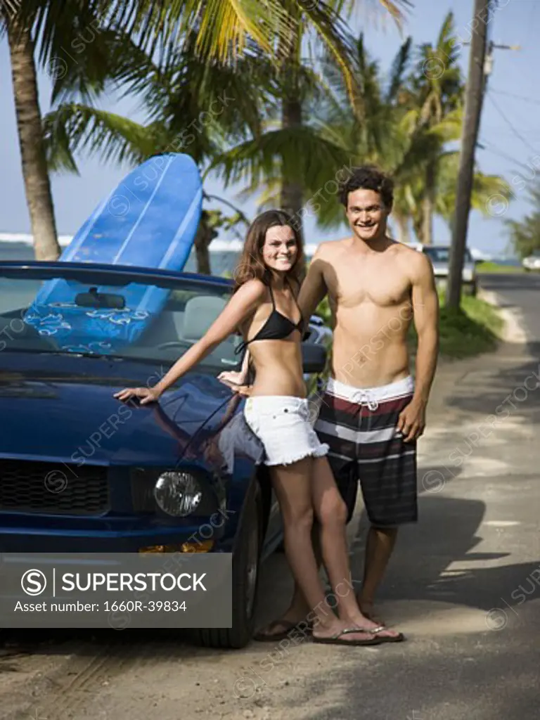 couple going to the beach to surf