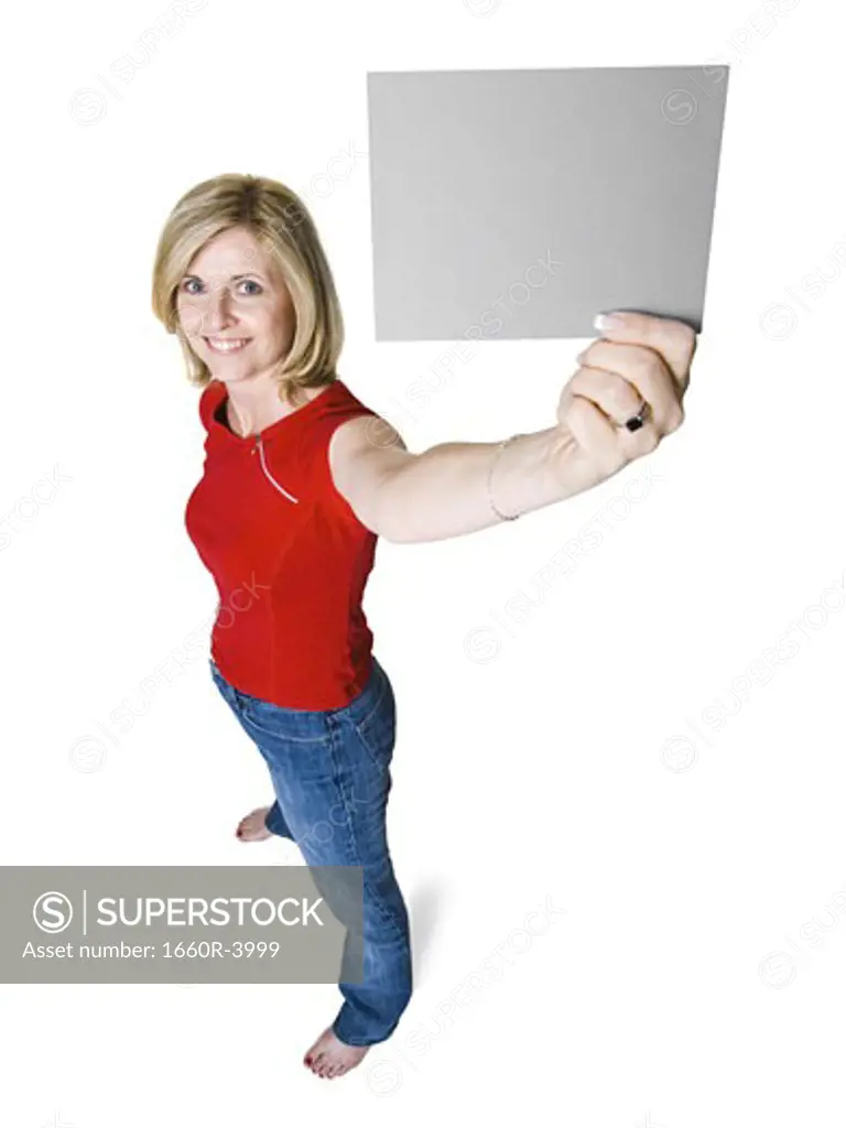 High angle view of a woman holding up a blank sign