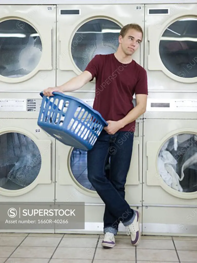 man doing laundry at a laundromat