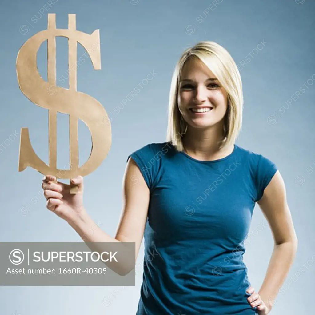 woman holding up a dollar symbol