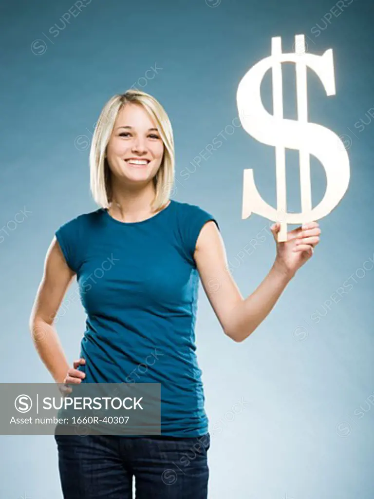 woman holding up a dollar symbol
