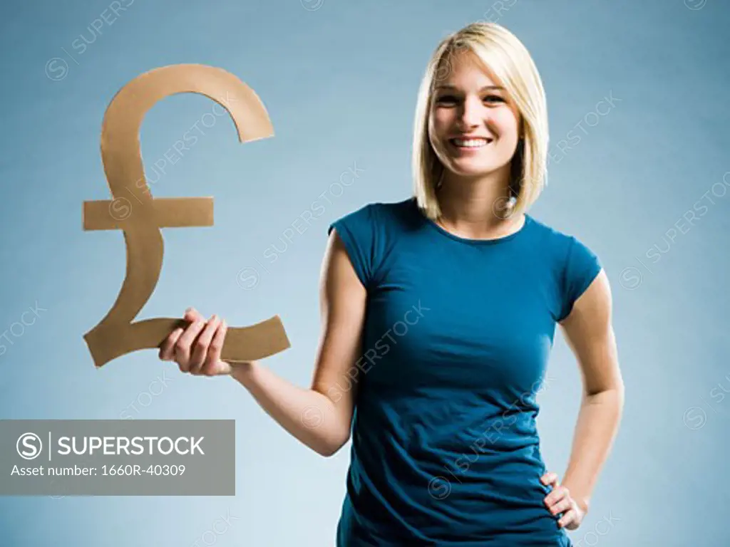 woman holding up a british pound symbol