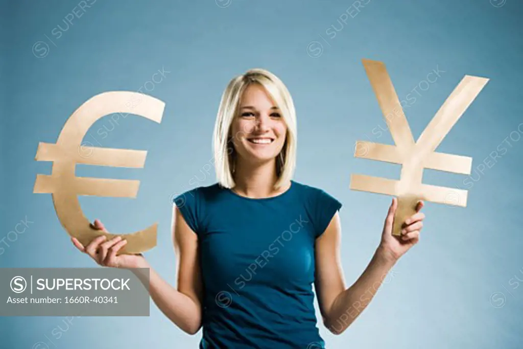 woman holding up currency symbols