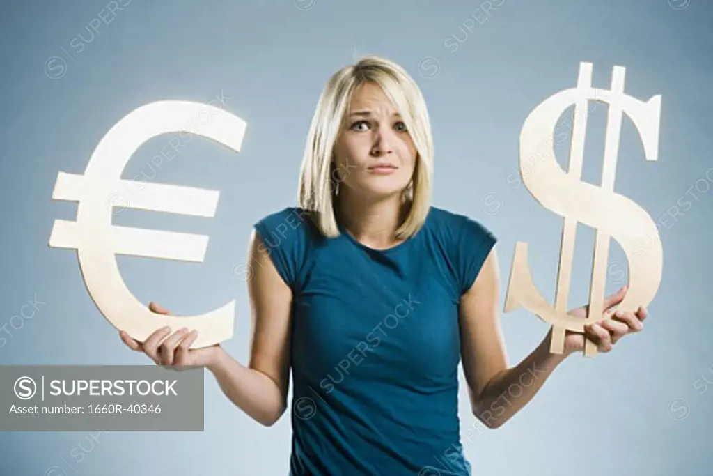 woman holding up currency symbols