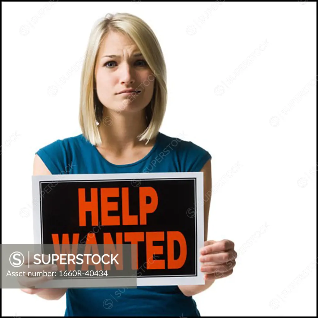 woman holding a help wanted sign