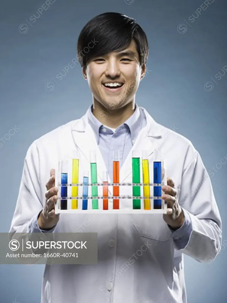 scientist holding test tubes