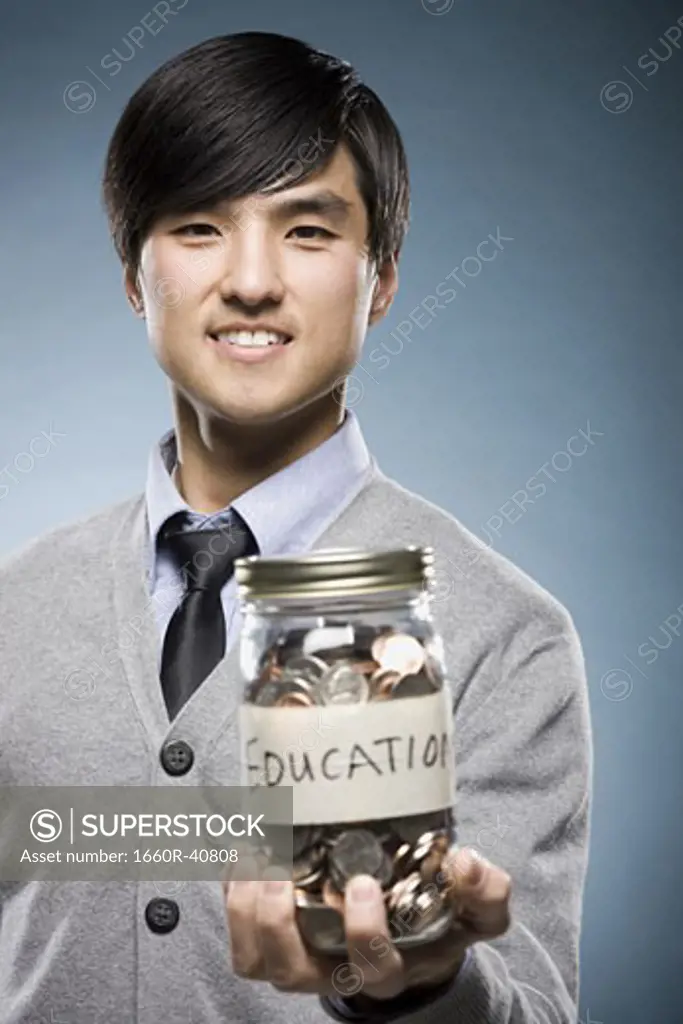 man holding a jar of coins