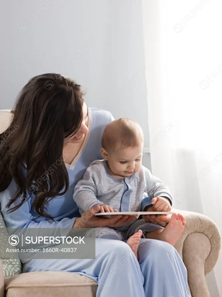 mother reading a book to her baby