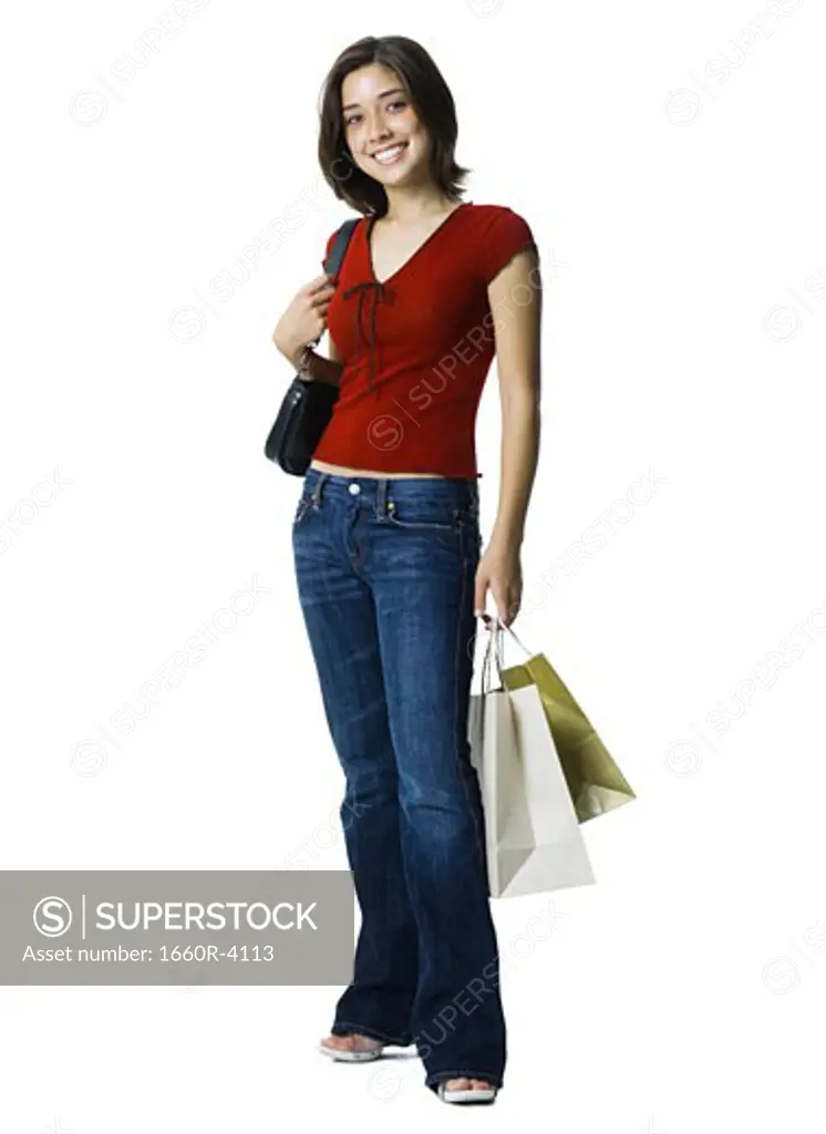 Portrait of a young woman holding shopping bags