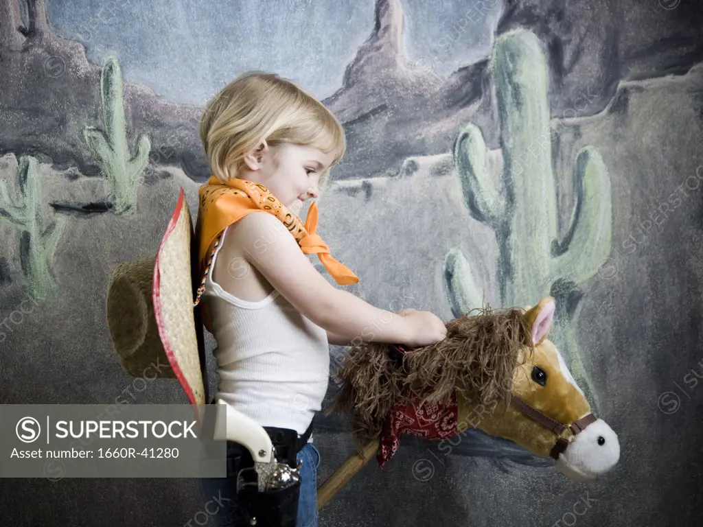 little girl dressing up as a cowgirl