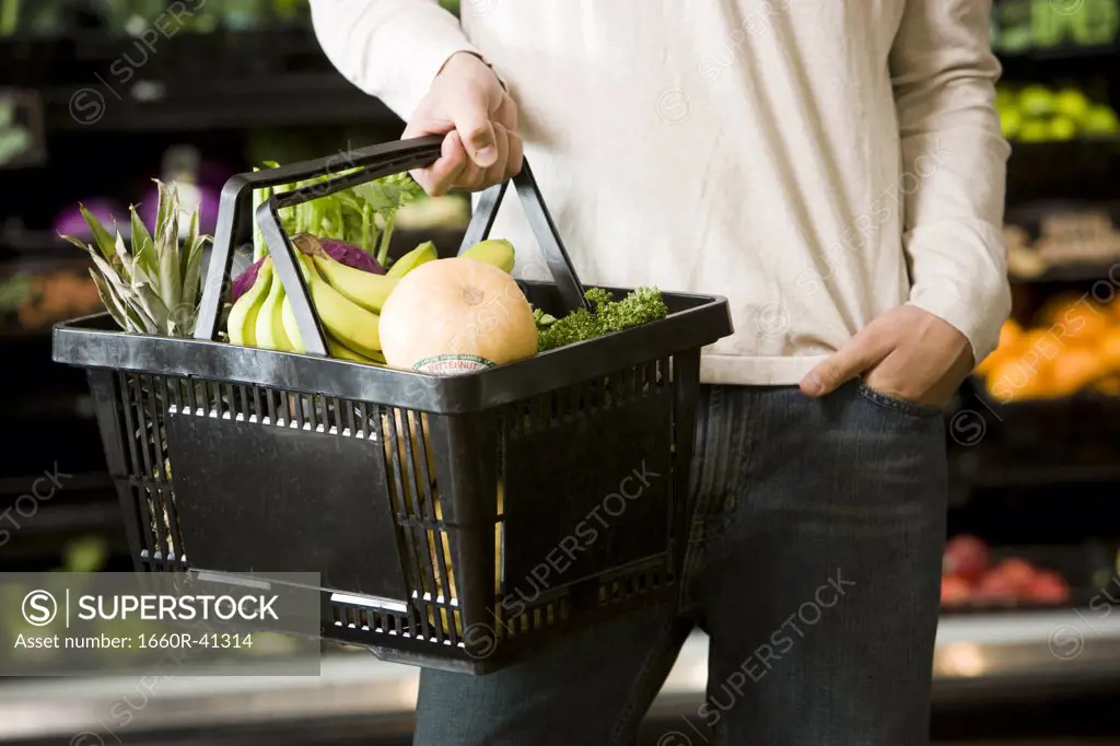 man holding a shopping basket
