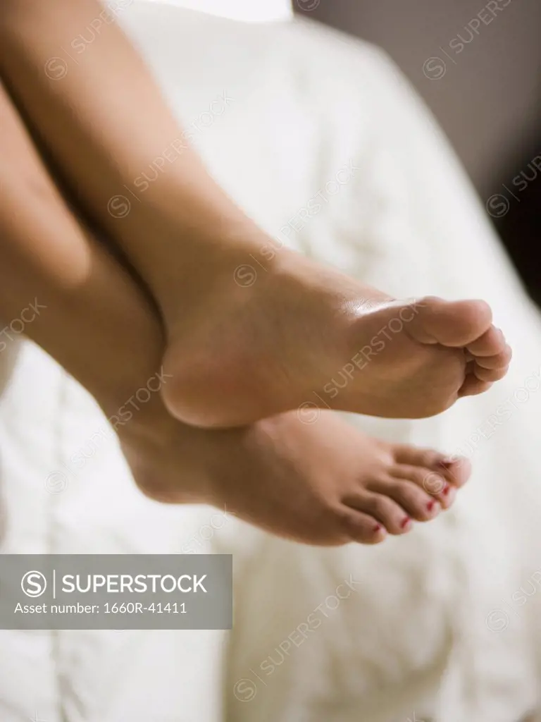 bare feet hanging off the bed