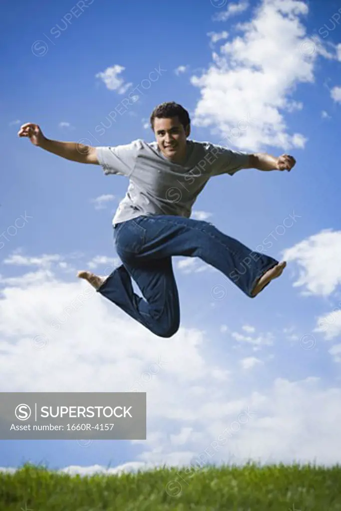 Low angle view of a young man jumping