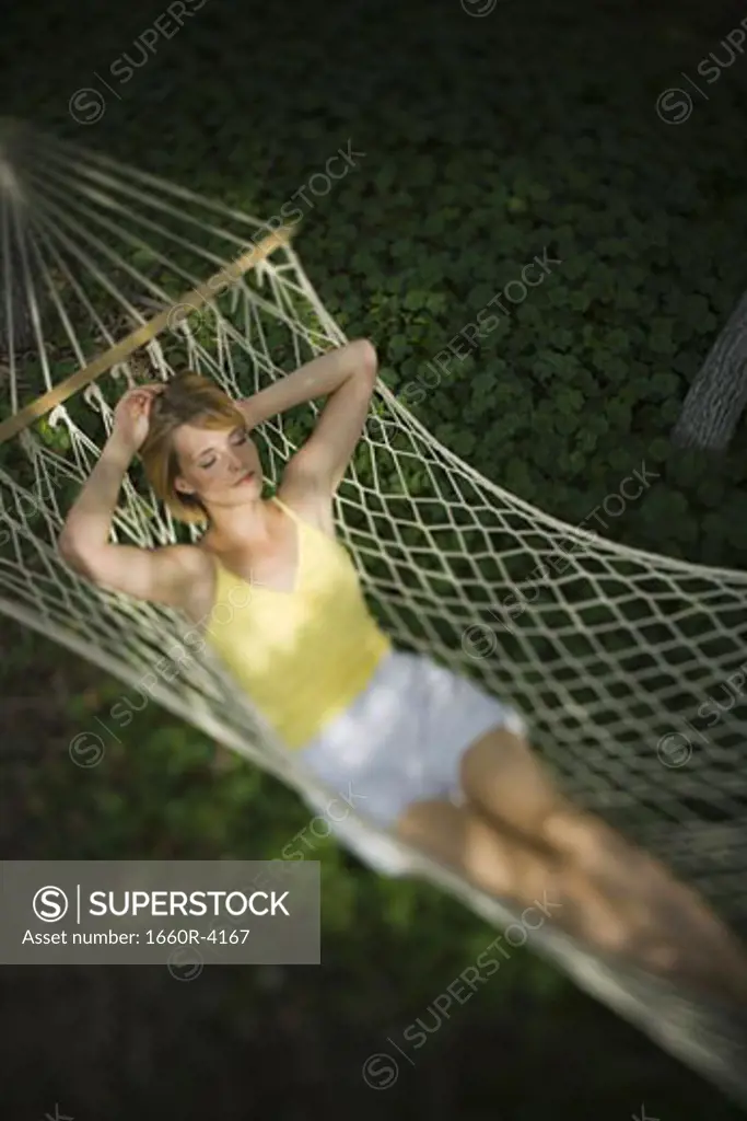 High angle view of a young woman relaxing in a hammock