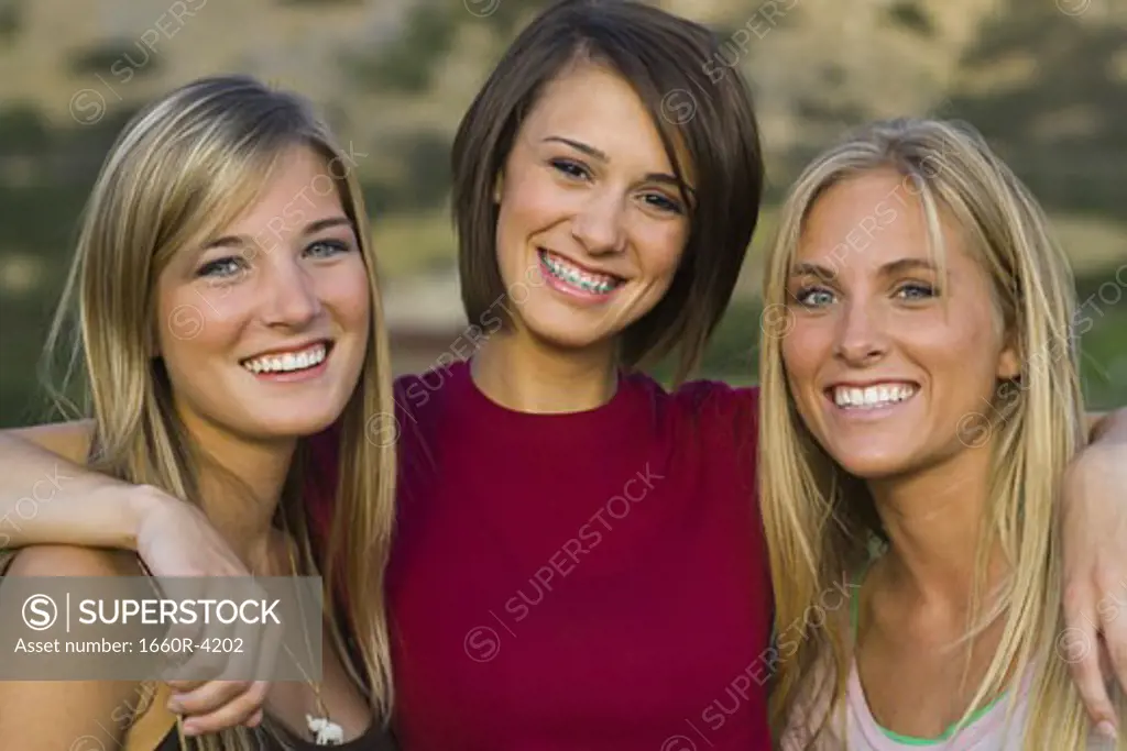 Portrait of three young women smiling