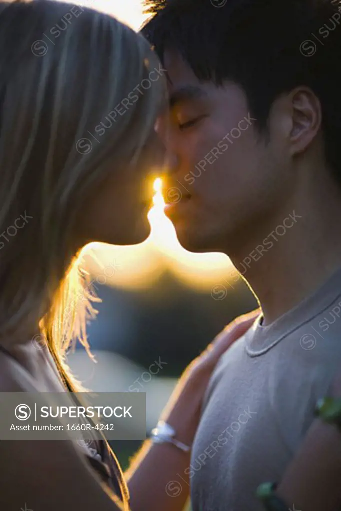 Portrait of a young man and woman kissing