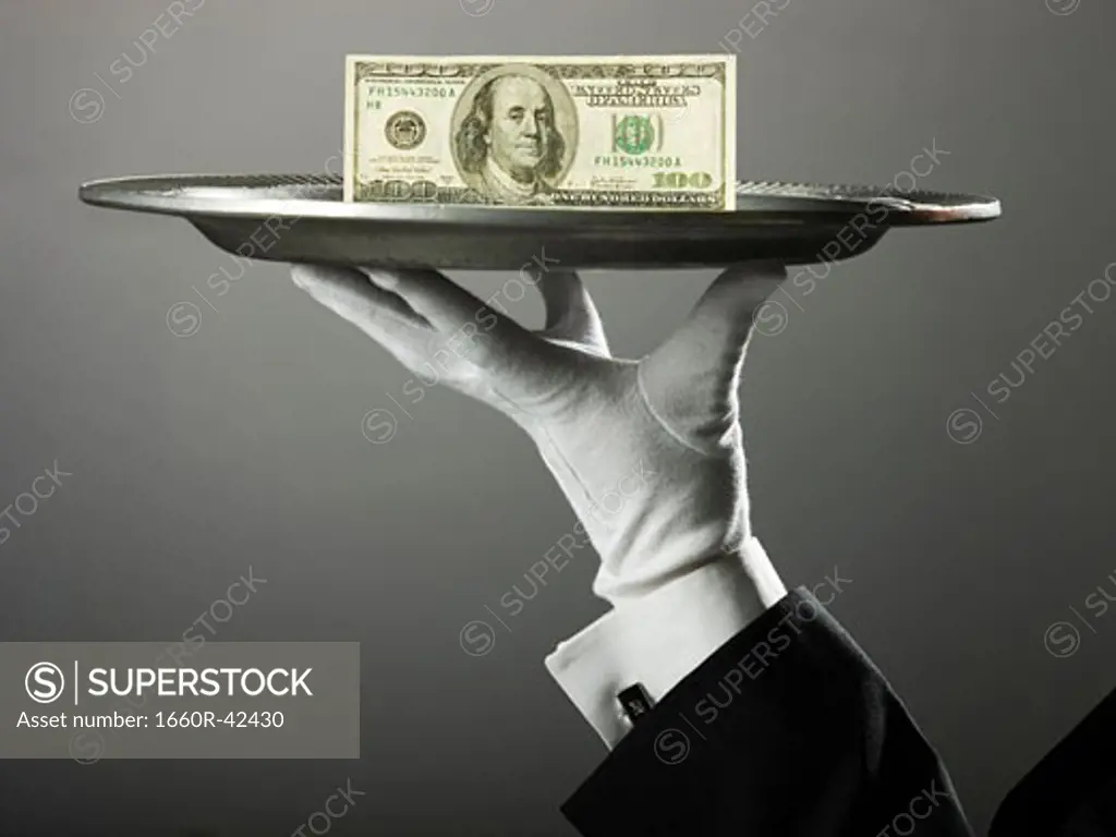 100 dollar bill on a platter