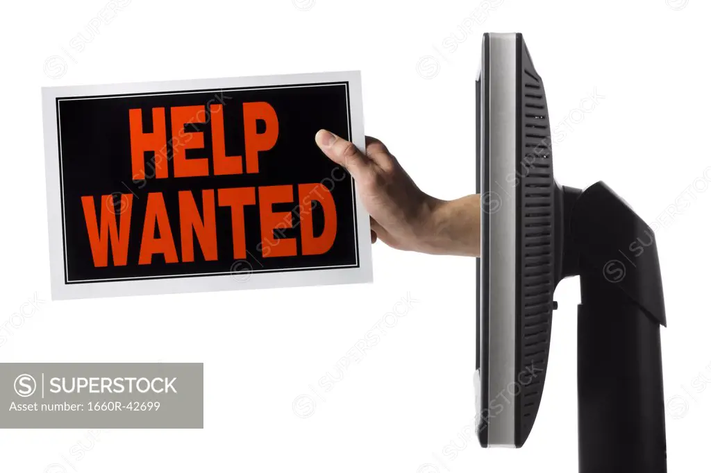 hand coming out of a computer with a help wanted sign