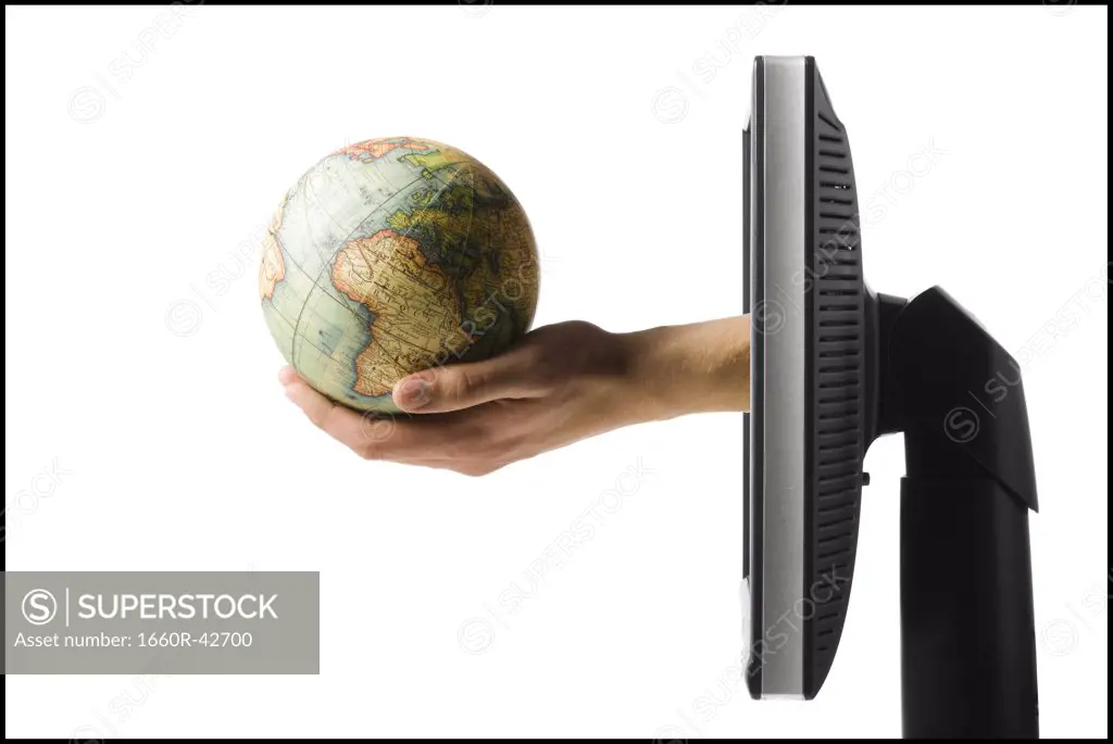 hand coming out of computer holding a globe