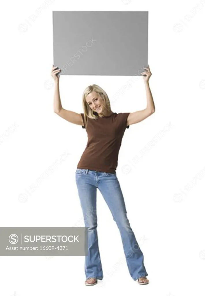 Portrait of a young woman lifting up a blank sign