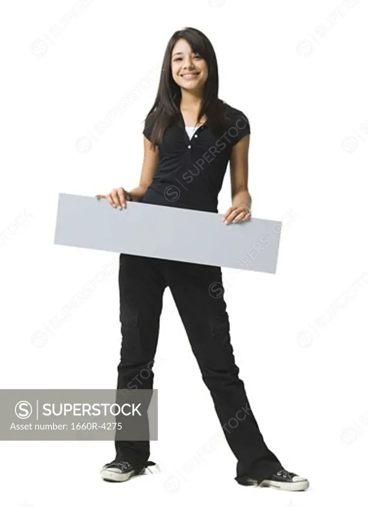 Portrait of a teenage girl holding a blank sign