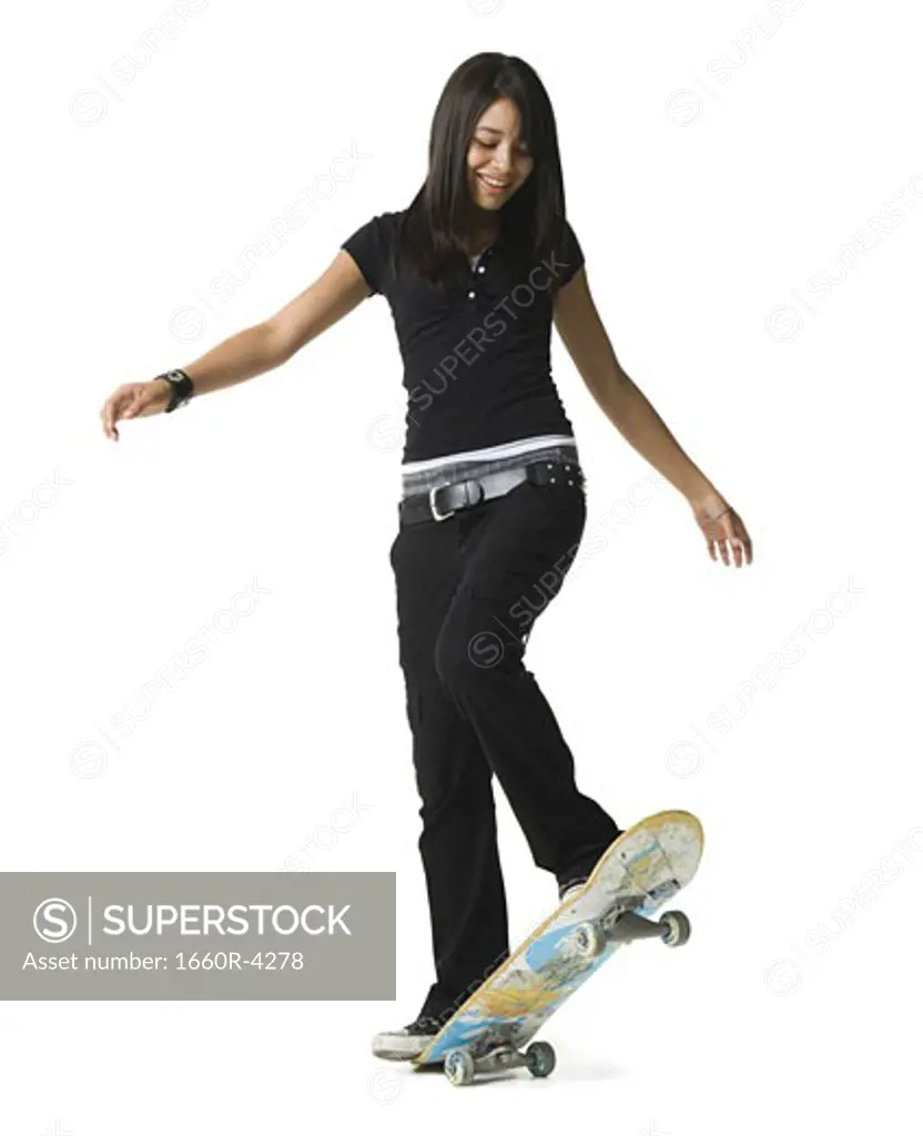 Teenage girl riding a skateboard