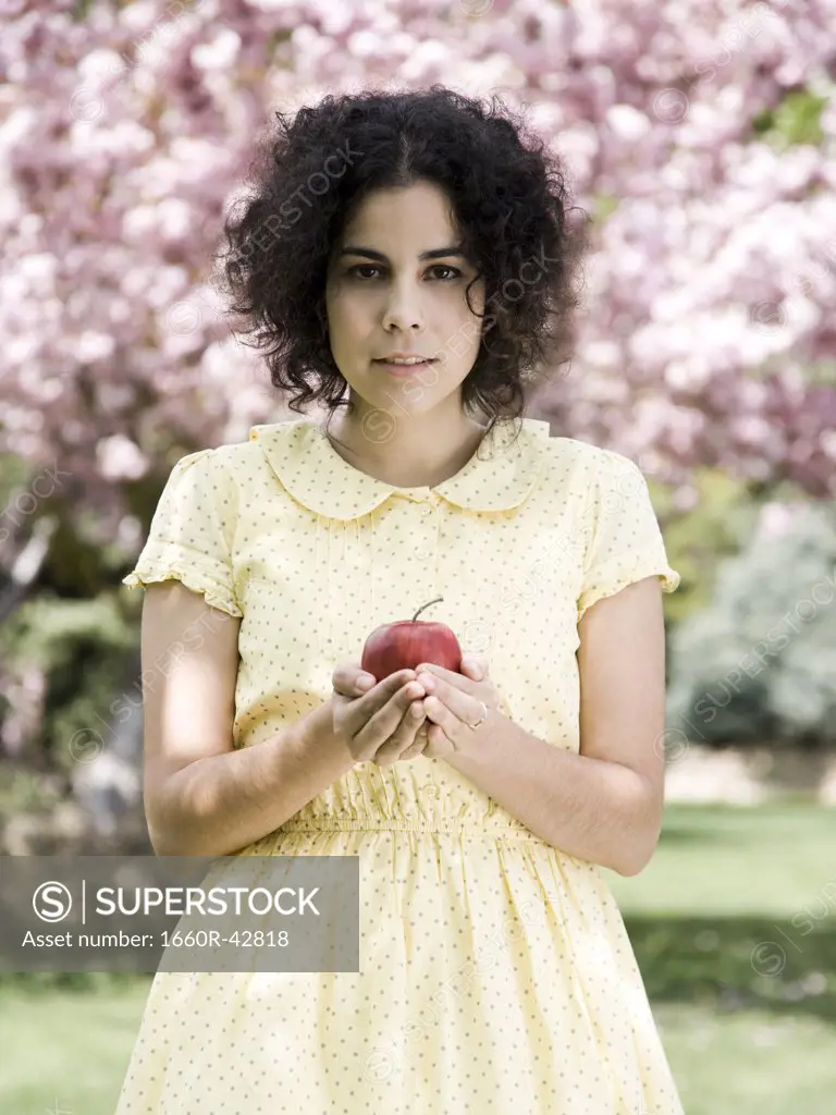 woman in a yellow dress with a red apple