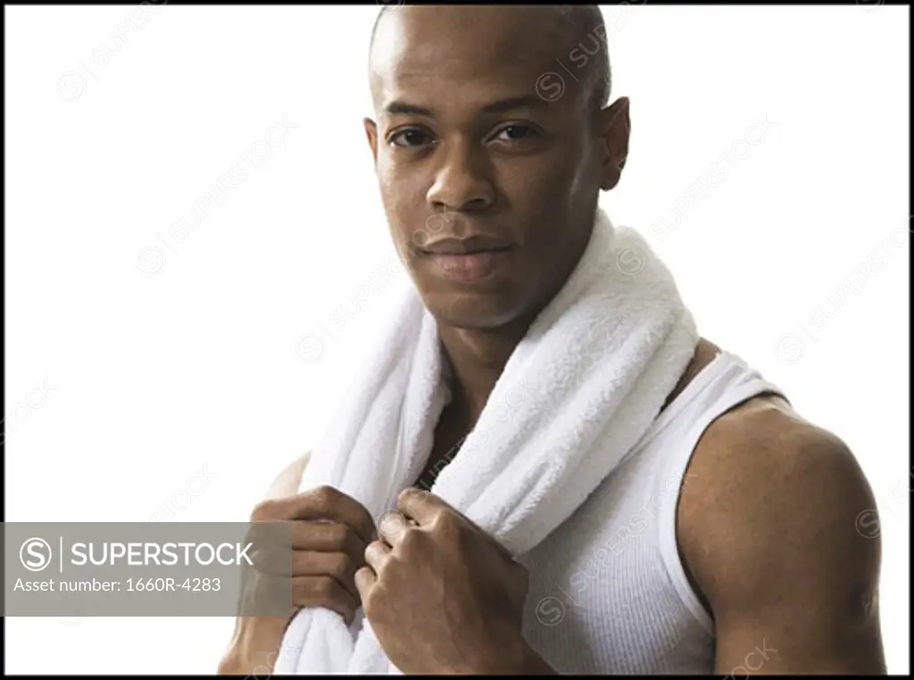 Portrait of a young man holding a towel around his neck