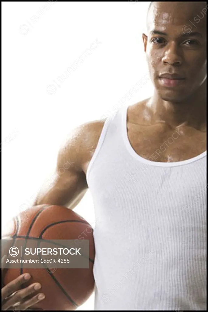 Portrait of a young man holding a basketball