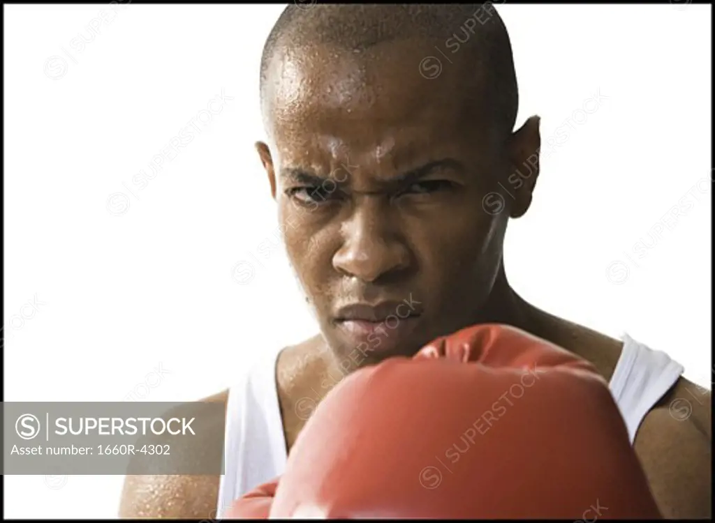 Portrait of a young man wearing boxing gloves