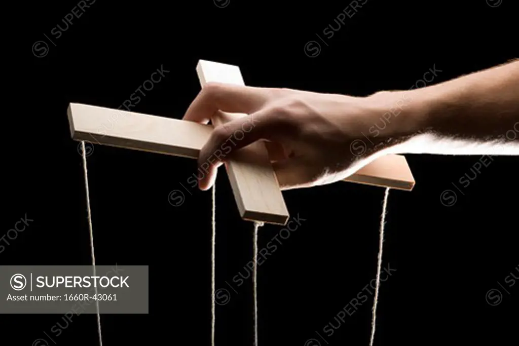 hand holding a puppet cross beam