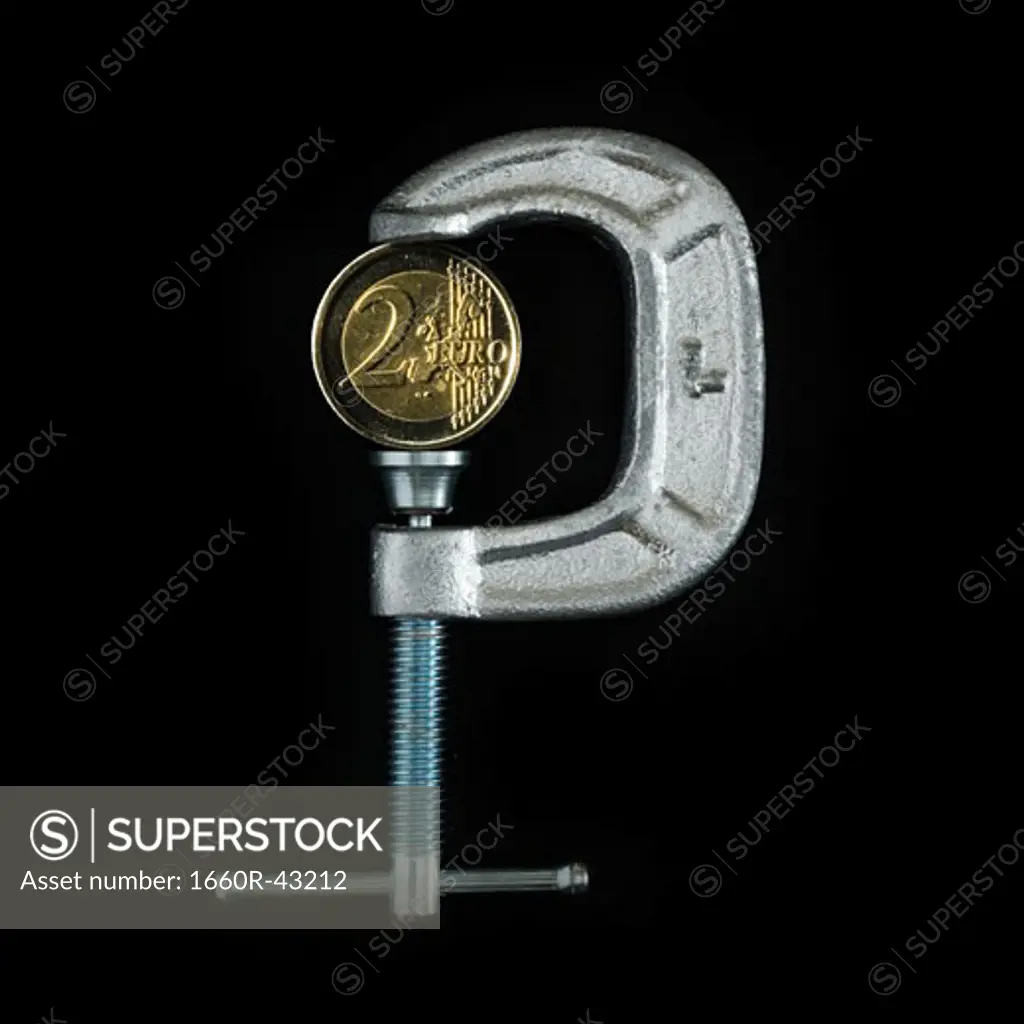 two euro coin in a metal clamp