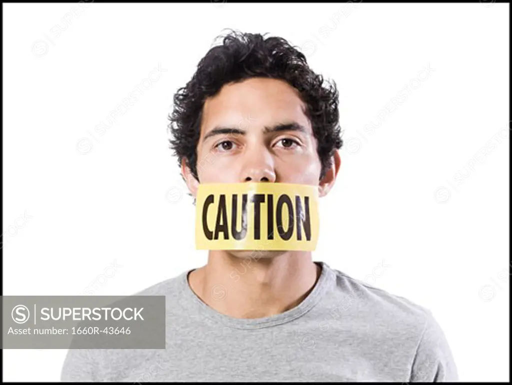 man with caution tape over his mouth