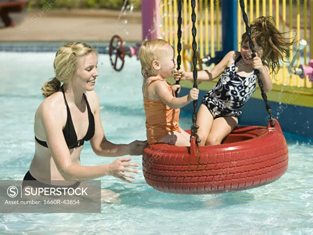 children on a tire swing at a waterpark