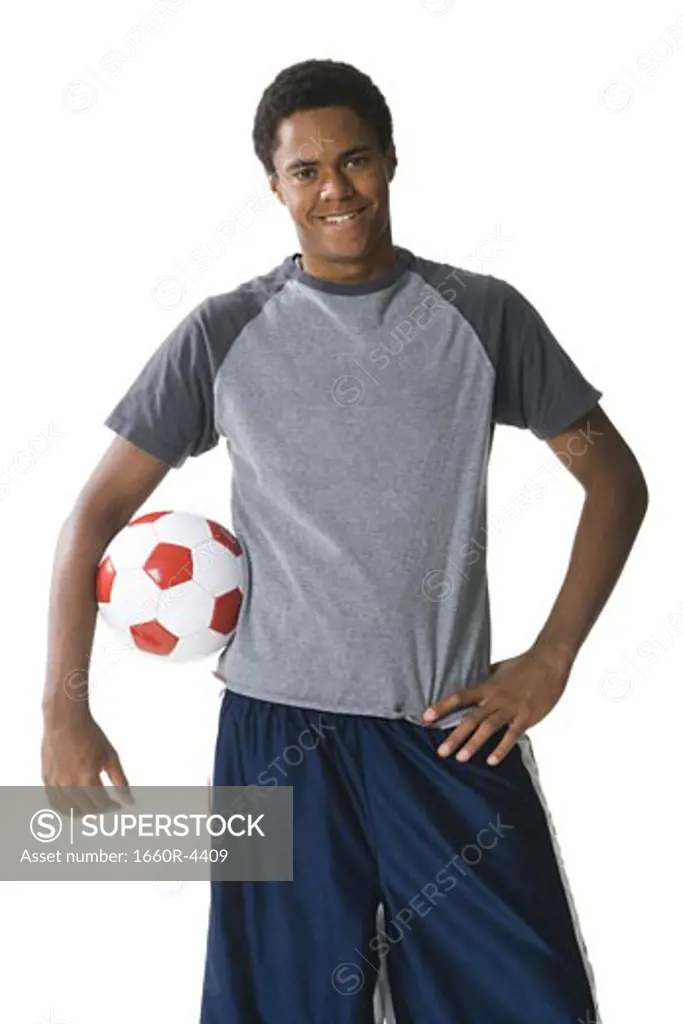 Portrait of a teenage boy with a football under his arm