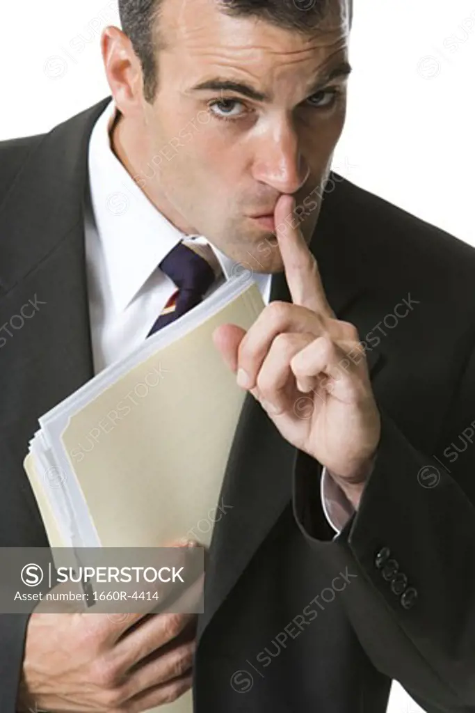 Portrait of a businessman hiding a file