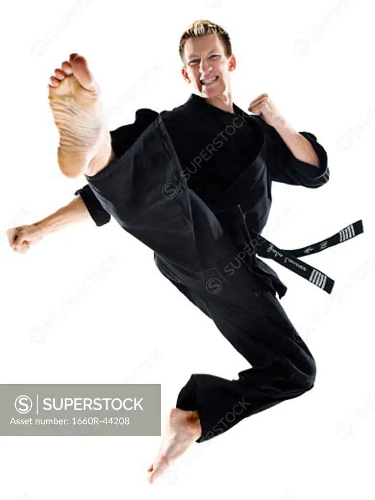 man in a black karate gi practicing martial arts
