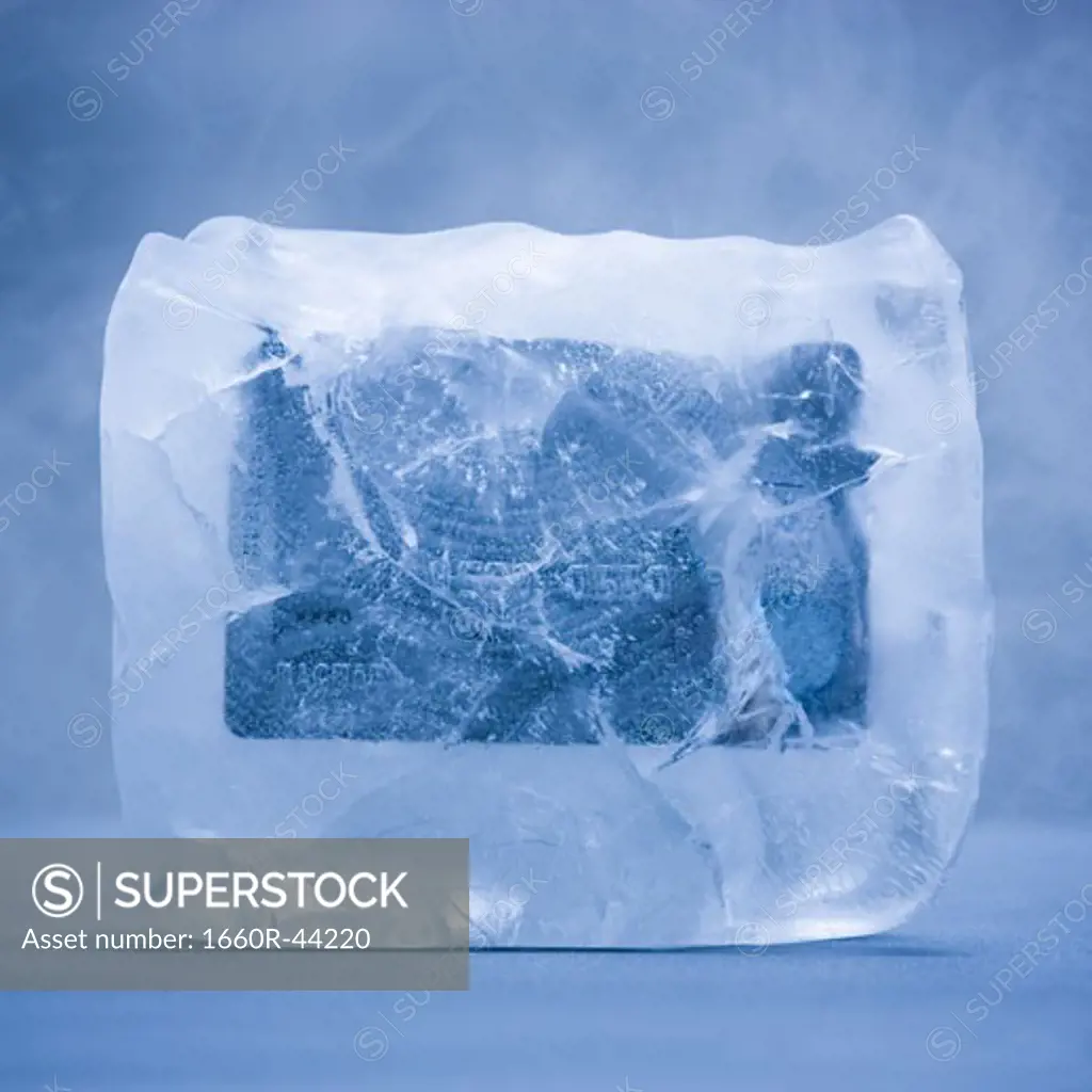 credit card frozen in a solid block of ice