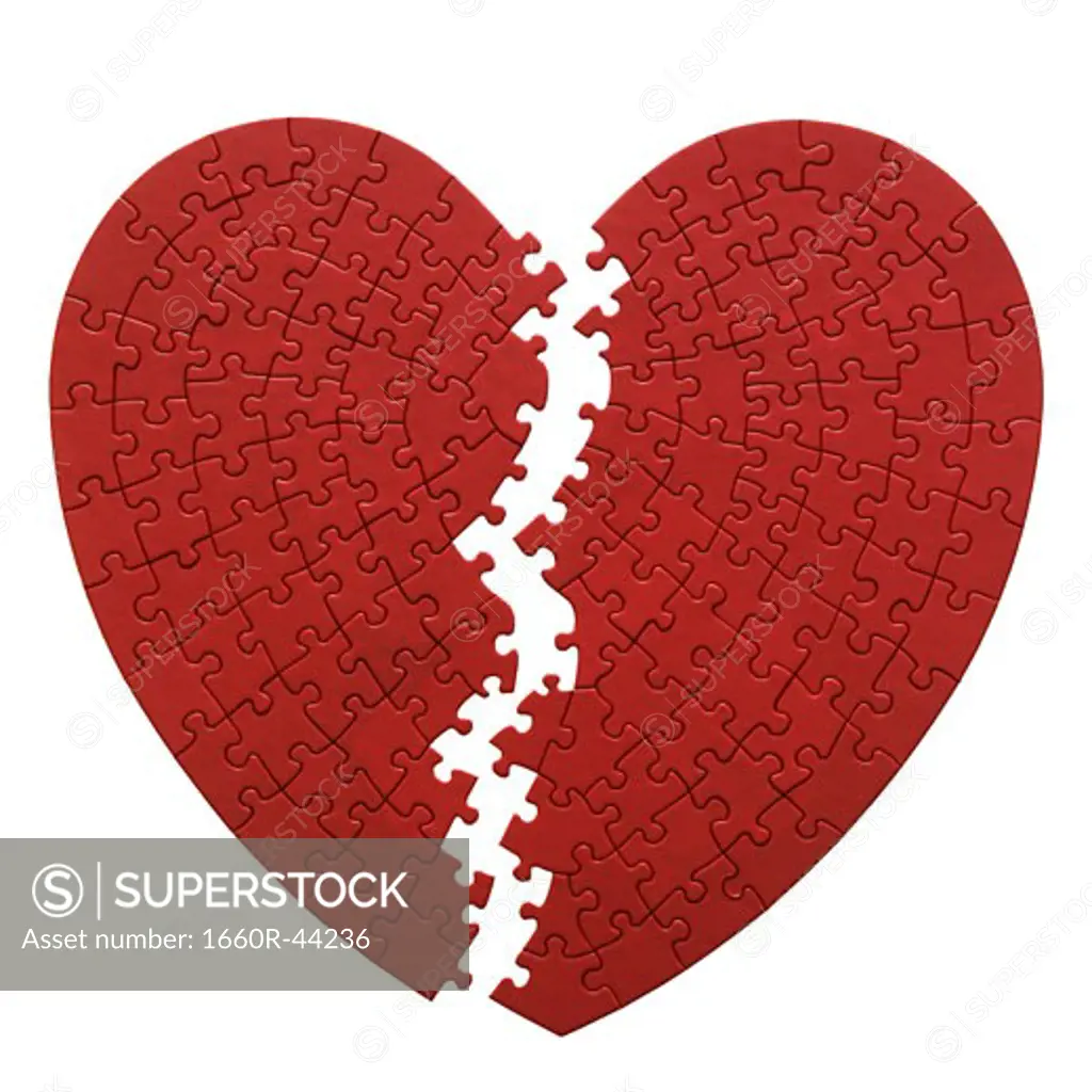 red heart shaped jigsaw puzzle on a white background