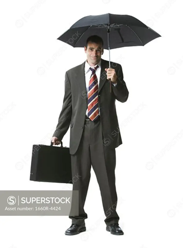 Portrait of a businessman standing with a briefcase and umbrella