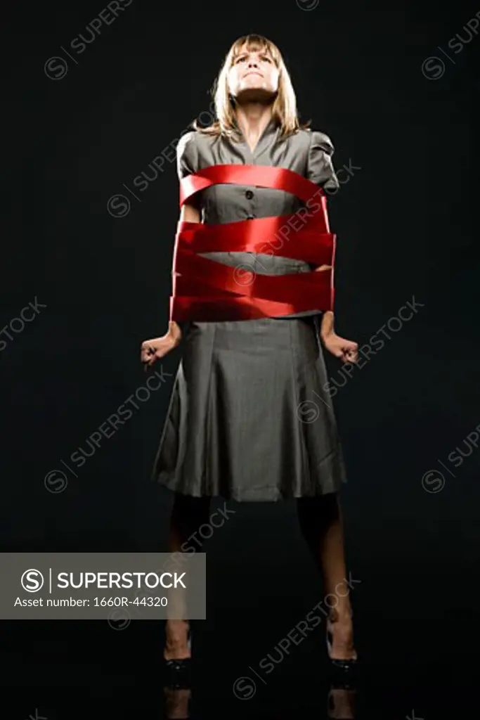 businesswoman all wrapped up in red ribbon