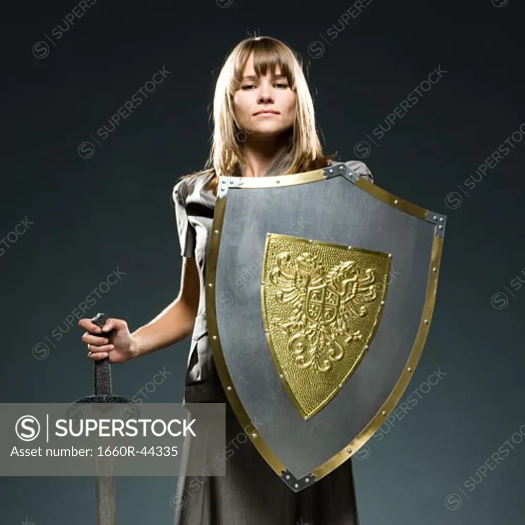 businesswoman holding a sword and a shield