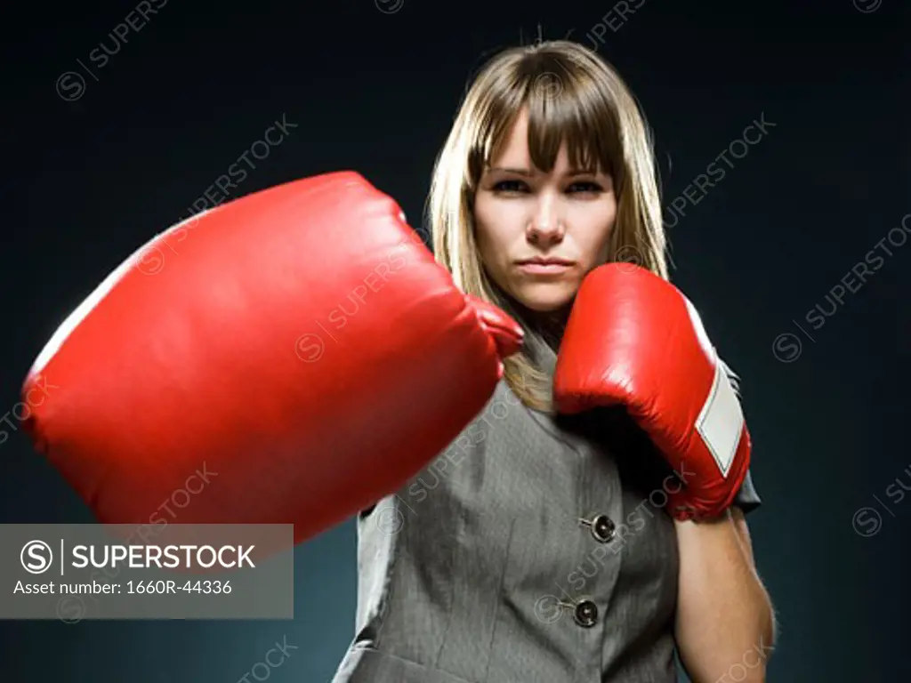 businesswoman wearing boxing gloves