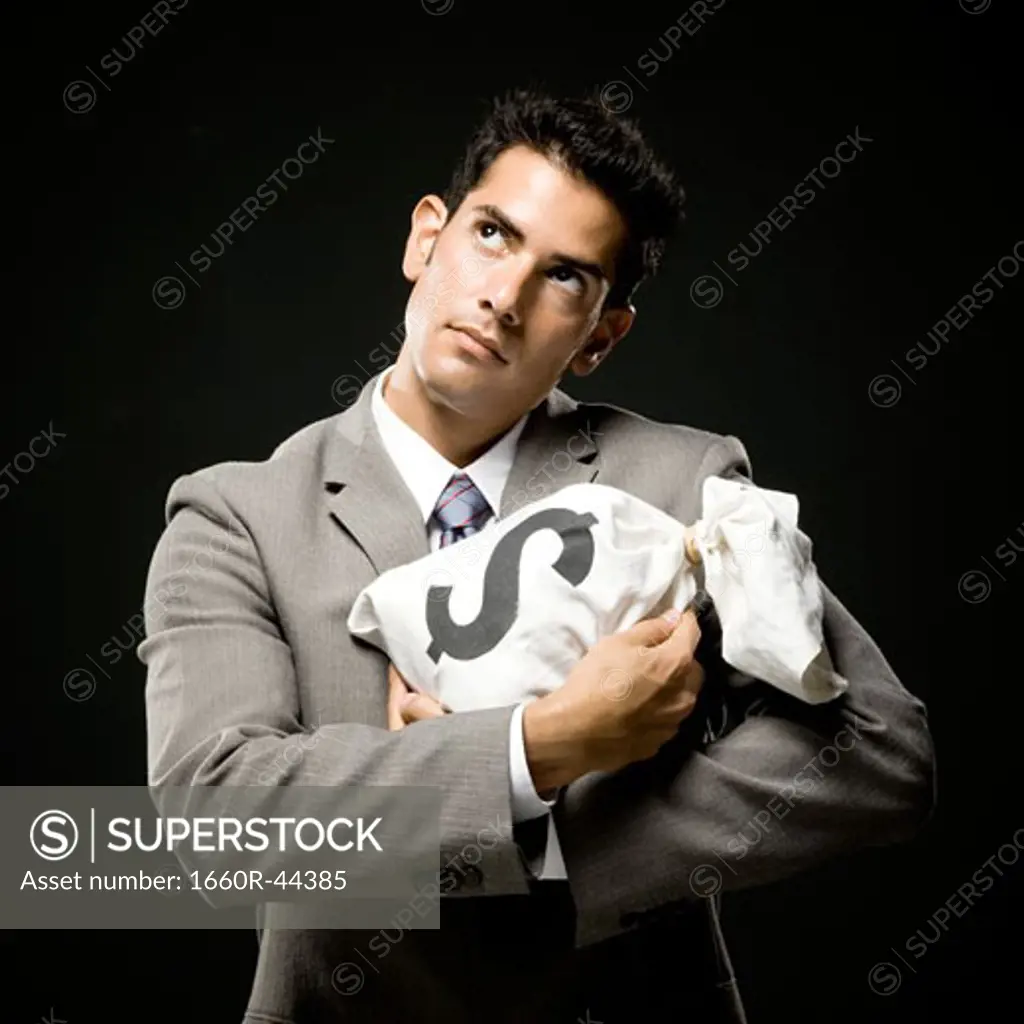 businessman holding a bag of money like a baby