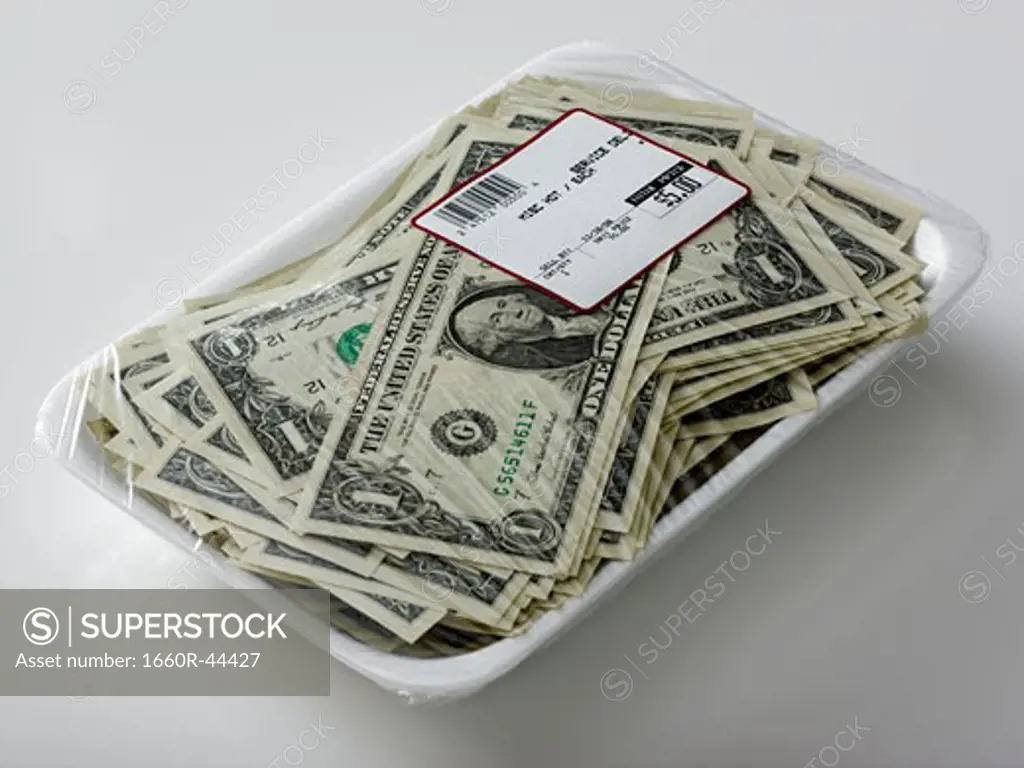 us dollars in a supermarket shrinkwrap package